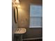 Cozy bathroom featuring a pedestal sink, oval mirror, and a bright window at 2137 Meadow Peak Rd, Duluth, GA 30097