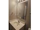 Well-lit bathroom featuring a single sink vanity and large mirror at 2137 Meadow Peak Rd, Duluth, GA 30097