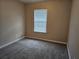 Cozy bedroom with a window providing natural light and neutral carpeting at 2137 Meadow Peak Rd, Duluth, GA 30097