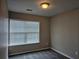 Bedroom with large window providing lots of natural light and neutral carpet at 2137 Meadow Peak Rd, Duluth, GA 30097