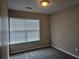 A small bedroom with neutral walls and a window for natural light at 2137 Meadow Peak Rd, Duluth, GA 30097