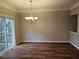 Dining room with sliding door access to deck and modern light fixture at 2137 Meadow Peak Rd, Duluth, GA 30097