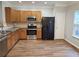 Kitchen featuring wood cabinets, stainless appliances, and wood flooring at 2137 Meadow Peak Rd, Duluth, GA 30097