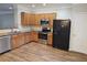 Kitchen featuring wood cabinets, stainless appliances, and wood flooring at 2137 Meadow Peak Rd, Duluth, GA 30097
