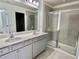 Elegant bathroom featuring double sinks, modern fixtures, and a glass-enclosed shower at 3677 Hidden Valley Cir, Lawrenceville, GA 30044