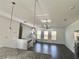 Bright living room with sleek hardwood floors, ceiling fan, and stylish pendant lights at 3677 Hidden Valley Cir, Lawrenceville, GA 30044