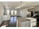 Open-concept living area with hardwood floors, modern lighting, and abundant natural light at 3677 Hidden Valley Cir, Lawrenceville, GA 30044