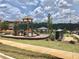 Community playground with a slide, swing set, and green space for outdoor activities at 3677 Hidden Valley Cir, Lawrenceville, GA 30044