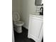 Compact bathroom with black tile flooring, new toilet, and single sink vanity at 6774 Collier Rd, Riverdale, GA 30296