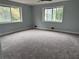 Bedroom featuring new carpeting, fresh paint and large windows for natural light at 6774 Collier Rd, Riverdale, GA 30296