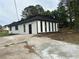Side view of a remodeled home showing the black trim windows and fresh exterior paint at 6774 Collier Rd, Riverdale, GA 30296