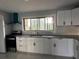 Updated kitchen featuring white cabinets, subway tile, and stainless steel appliances at 6774 Collier Rd, Riverdale, GA 30296