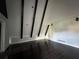 Open living room with dark wood floors, beamed ceilings, and modern trim at 6774 Collier Rd, Riverdale, GA 30296