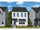Charming two-story home with vertical siding and a welcoming teal-colored front door at 754 Auguste Ave, Decatur, GA 30033