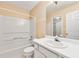 Clean bathroom with a white tub, toilet, sink and a decorative wallpaper at 3040 Majestic Park Ct, Duluth, GA 30096
