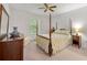 Cozy bedroom with a four-poster bed, neutral walls, and natural light from the windows at 3040 Majestic Park Ct, Duluth, GA 30096