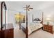 Serene bedroom with canopy bed, neutral carpet, and sliding door access to outdoor space at 3040 Majestic Park Ct, Duluth, GA 30096