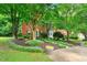 Charming two-story brick home with a beautifully landscaped front yard and mature trees at 3040 Majestic Park Ct, Duluth, GA 30096