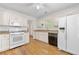 Bright kitchen featuring white cabinets, modern appliances, and hardwood floors at 3040 Majestic Park Ct, Duluth, GA 30096