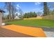 Expansive backyard featuring a wooden deck and a well-maintained lawn surrounded by a privacy fence at 3470 Glenwood Rd, Decatur, GA 30032