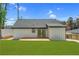 Large backyard with a well-kept lawn, featuring an expansive patio area and privacy fencing at 3470 Glenwood Rd, Decatur, GA 30032