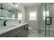 Bright bathroom showcasing a double vanity with marble countertop and a glass enclosed walk-in shower with bench seat at 3470 Glenwood Rd, Decatur, GA 30032