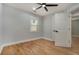 Comfortable bedroom with hardwood floors, a ceiling fan, and access to a closet at 3470 Glenwood Rd, Decatur, GA 30032