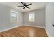 Well-lit bedroom with hardwood floors, two windows, and neutral wall colors at 3470 Glenwood Rd, Decatur, GA 30032
