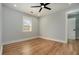 Cozy bedroom with hardwood floors, a ceiling fan, and natural light from the window at 3470 Glenwood Rd, Decatur, GA 30032