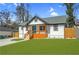 Beautifully renovated home with a modern exterior, inviting porch and manicured lawn at 3470 Glenwood Rd, Decatur, GA 30032