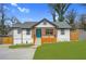 Charming renovated home featuring a welcoming front porch and fresh landscaping at 3470 Glenwood Rd, Decatur, GA 30032