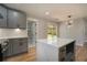 Bright kitchen featuring a quartz island, grey cabinetry, and stainless steel appliances at 3470 Glenwood Rd, Decatur, GA 30032