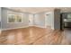 Open-concept living room featuring hardwood floors, a large window, and access to the kitchen at 3470 Glenwood Rd, Decatur, GA 30032