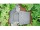 Birds-eye view of gray roof with chimney, surrounded by lush green trees and a wood deck at 3966 N Indian Nw Cir, Kennesaw, GA 30144