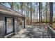 Back deck is constructed of gray wood, offers access to the house and overlooks natural surroundings at 3966 N Indian Nw Cir, Kennesaw, GA 30144
