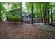 Backyard view of the house with a deck and the surrounding lush green forest-like tree coverage at 3966 N Indian Nw Cir, Kennesaw, GA 30144