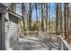 Back deck is constructed of gray wood and overlooks natural surroundings and the tree line at 3966 N Indian Nw Cir, Kennesaw, GA 30144