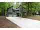 Charming two-story home featuring a two-car garage, and a long driveway, surrounded by mature trees at 3966 N Indian Nw Cir, Kennesaw, GA 30144