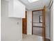Hallway features tile flooring, a storage cabinet and access to another room with natural lighting at 3966 N Indian Nw Cir, Kennesaw, GA 30144