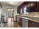 Traditional kitchen featuring granite countertops, tile backsplash, stainless steel appliances and dark wood cabinetry at 3966 N Indian Nw Cir, Kennesaw, GA 30144