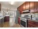 Kitchen showcasing stainless steel appliances, granite counters, dark cabinetry and open access to a breakfast area at 3966 N Indian Nw Cir, Kennesaw, GA 30144