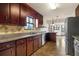 Kitchen featuring granite countertops, tile backsplash, stainless steel appliances and dark wood cabinetry at 3966 N Indian Nw Cir, Kennesaw, GA 30144