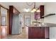The kitchen features stainless steel appliances, dark wood cabinetry, granite counters and peninsula seating at 3966 N Indian Nw Cir, Kennesaw, GA 30144