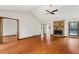 Spacious living room featuring a stone fireplace, hardwood floors, and views to a porch at 3966 N Indian Nw Cir, Kennesaw, GA 30144