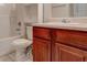 Bathroom featuring a vanity with wood cabinets, a sink, a toilet, and a shower/tub combo at 6684 Crane Ave, Fairburn, GA 30213