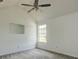 Bright bedroom featuring neutral walls, carpet, a ceiling fan, and a window at 6684 Crane Ave, Fairburn, GA 30213