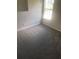 Bedroom with neutral carpet and bright window light, offering calm and relaxation at 6684 Crane Ave, Fairburn, GA 30213
