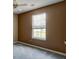 Bedroom with neutral walls, ceiling fan, and large window that lets in natural light at 6684 Crane Ave, Fairburn, GA 30213
