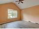 Bright bedroom featuring warm walls, laminate flooring, a ceiling fan, and a window at 6684 Crane Ave, Fairburn, GA 30213
