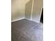 Neutral bedroom with plush carpeting and natural light streaming in from an open doorway at 6684 Crane Ave, Fairburn, GA 30213